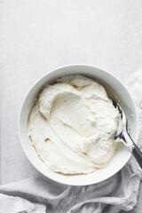Greek yogurt in a white bowl, process of making Greek yogurt, strained yogurt in ceramic white bowl
