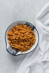  Jollof rice on a white plate, homemade nigerian jollof rice on a plate, overhead view of authentic homemade west african jollof rice