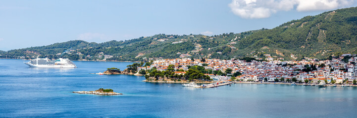 Fototapeta na wymiar Skiathos town with cruise ship vacation panorama at the Mediterranean Sea Aegean island in Greece