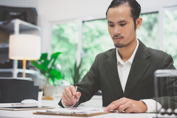 Handsome young ambitious developer working alone at the office 