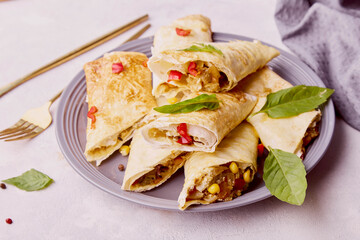 Southwest Chicken Egg Rolls wirh corn, red bell peppers, jalapenos, black beans, cheese, chicken, sweet and spicy seasoning in an egg roll wrapper.