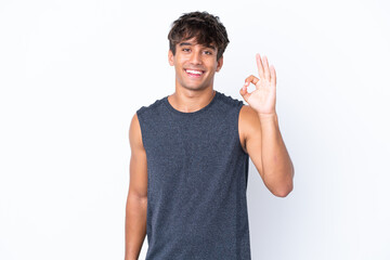 Young sport caucasian man isolated on white background showing ok sign with fingers