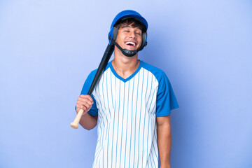 Baseball caucasian man player with helmet and bat isolated on blue background laughing