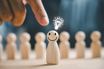 In a concept of creativity and inspiration, a wooden person stands with a light bulb, symbolizing imaginative thinking. Leadership encourages teamwork and idea sharing, resulting in innovation.