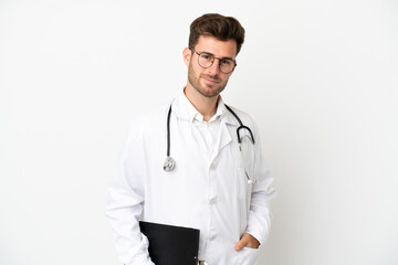 Young doctor caucasian man over isolated on white background wearing a doctor gown and holding a folder