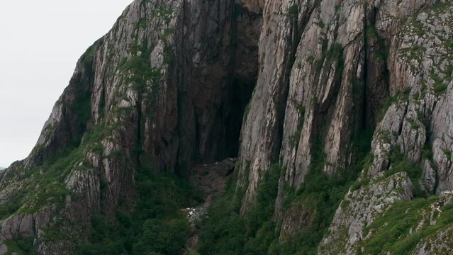 Mystic hole through Norwegian Torghatten mountain at dusk; drone