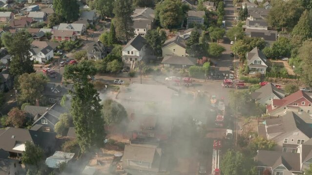 Establishing aerial shot around a burning suburban American home