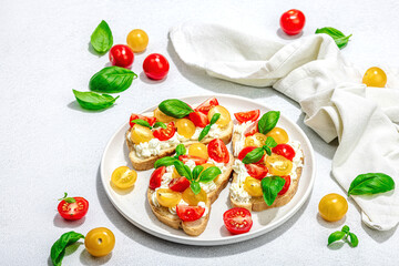 Fresh bread sandwiches with tomato cherry, cream cheese and basil leaves. Morning breakfast concept