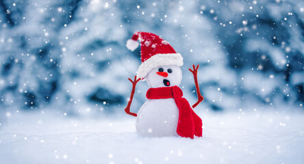 Little knitted snowman on the white snow on blue background.