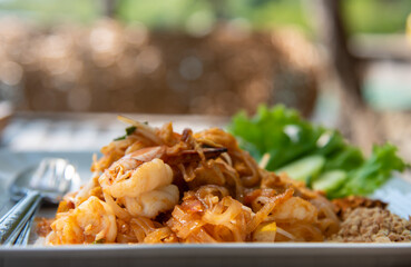 Pad thai, thai style noodle with shrimps. Fried noodle with prawns closeup image.