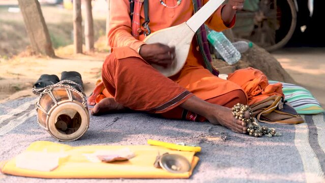 An Indian folk artist singing in soulful melodies, weaving harmonious tunes into the tranquil surroundings.
