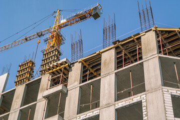 The foundation on reinforced concrete piles and the frame during the construction of a multi-storey building. Reinforcement of reinforced concrete columns. Construction of high-rise buildings.