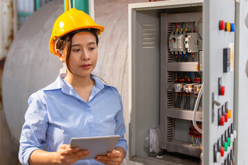 Electrician Engineer woman working check service maintenance electricity main circuit fuse and...