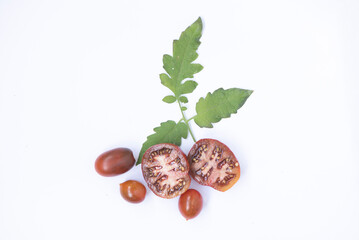 Fresh tomatoes, cut into halves with leaves. Different shapes and varieties. Prevention of fungal...