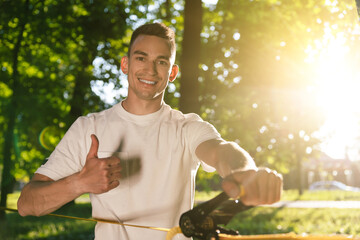 Young smiling man in the forest practising slacklining