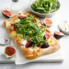 Homemade pizza with figs and arugula