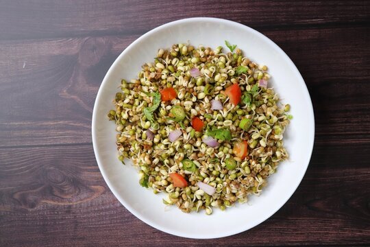 Sprouted moong beans. Protine rich salad. Healthy snack items. Sprouted Lentil Salad. Mixed with Onion, tomatoes, green chili and coriander. Copy space. Sprout Bhel.
