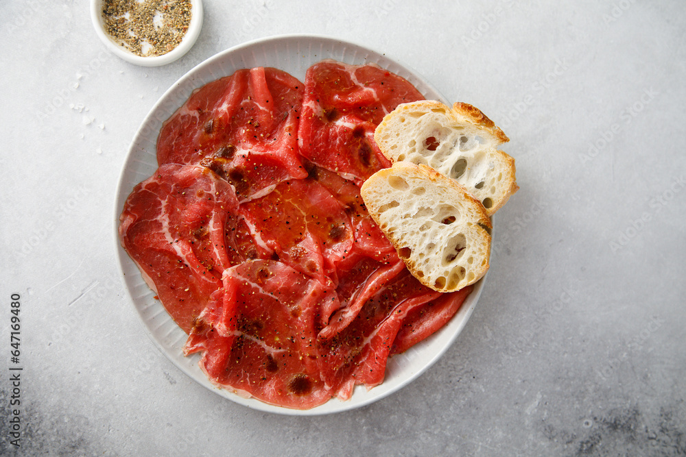 Canvas Prints Traditional beef carpaccio with baguette bread