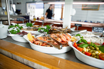 delicious shrimp on a serving plate on the buffet table in the restorant. Seafood buffet lunch in a cafe