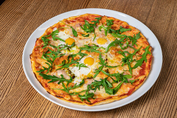 Margarita pizza with arugula and egg for breakfast, selective focus