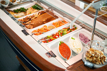 Variety fish dishes served buffet lunch. Healthy seafood dinner restaurant buffet menu