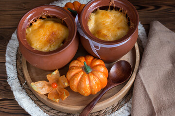 a clay pot with baked cheese on a woven napkin. Village concept