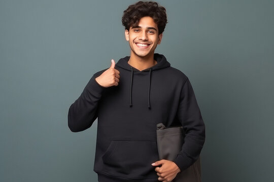Young college boy showing thumps up