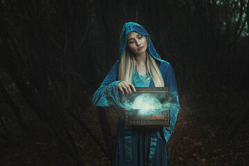 Elfin girl opens a magical box. Moon inside - 647183226