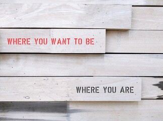 Wood wall with text WHERE YOU ARE and WHERE YOU WANT TO BE, concept of to achieve life or career...