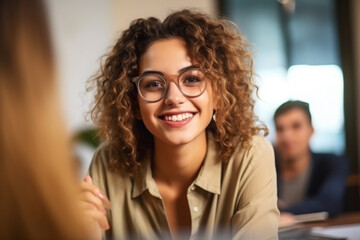 Smiling Female Manager Interviewing an Applicant In Office