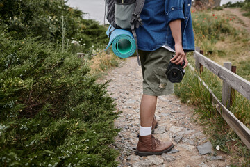 travel and photography concept, cropped view of happy indian man taking photo on digital camera