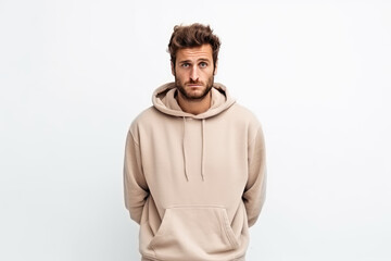 Fototapeta premium Sadness European Man In Beige Sweatshirt On White Background