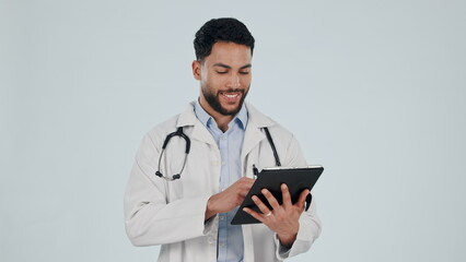 Doctor, man and tablet for healthcare service, social media and clinic software, internet scroll or research in studio. Happy medical worker on digital technology or hospital app on white background