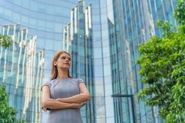 Portrait of a successful Caucasian businesswoman in front a modern office buildings in the city center