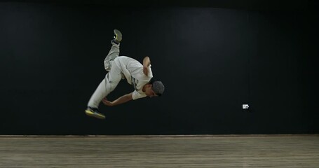 Super slow motion free running acrobat in the gym shot on 300fps 4K - Powered by Adobe