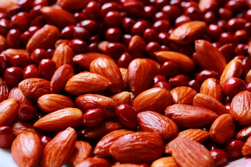 Close-up of almonds and peanuts, Background of big raw peeled almonds and peanuts, Peeled almonds and peanuts closeup background