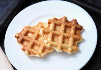 Fresh delicious homemade waffles on white plate. Delicious breakfast concept