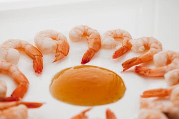 Peeled shrimps in a bowl isolated on white background. Top view