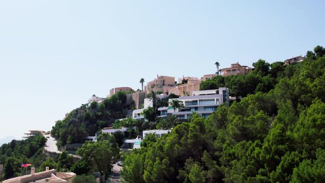 Aerial footage of summer holiday destination, Altea Hills, gated community in Costa Blanca, Spain. Vacation rentals and villas with private pool. Spanish real estate on Mediterranean coast
