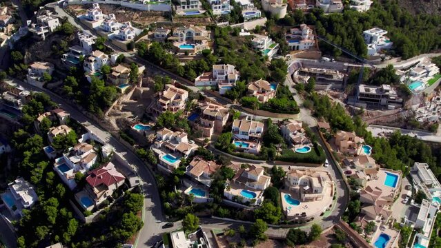 Aerial footage of summer holiday destination, Altea Hills, gated community in Costa Blanca, Spain. Vacation rentals and villas with private pool. Spanish real estate on Mediterranean coast