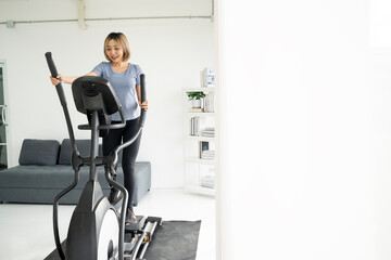 Women cycling on exercise bike during sports training at home