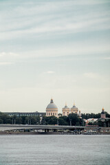 The embankment of a beautiful wide river in a large ancient city.