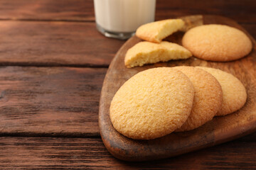 Delicious Danish butter cookies on wooden table, closeup. Space for text