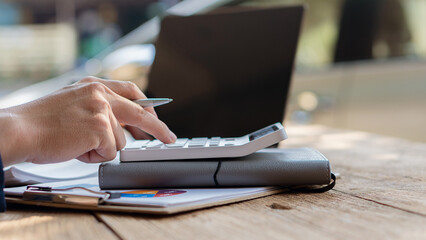 Accountant analyzes invoice investment chart and presses calculator button over document Accounting clerk, bank consultant and auditor in office close-up photo