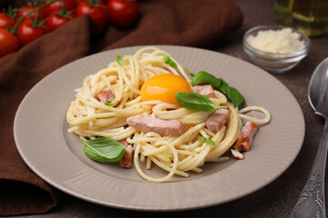 Delicious pasta Carbonara with egg yolk on table, closeup