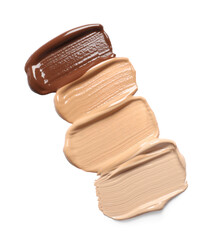 Samples of skin foundation on white background, top view