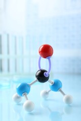 Molecular model on light surface against blurred background