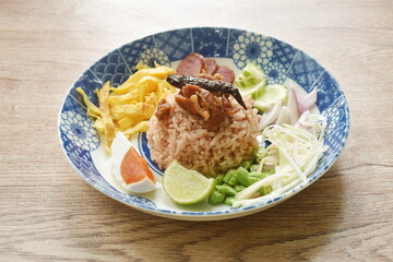 fried rice mixed with shrimp paste eat couple egg and vegetable on plate