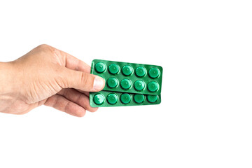 Middle aged male hand holding green blister pack with pills isolated on transparent background, healthcare and medicine concept