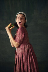 Medieval woman in historical attire, dress in image of renaissance maid emotional eating burger...